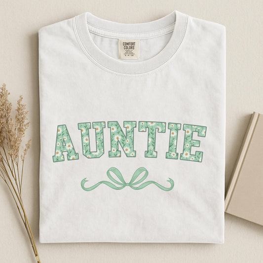 woman wearing dark brown sweatshirt with white script “Aunts” and bow design, cozy gift idea for new aunt or pregnancy reveal