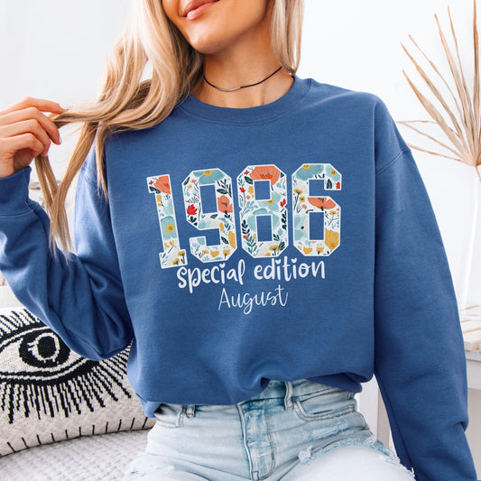 White crewneck sweatshirt featuring floral patterned 1986 numbers with special edition June text, feminine retro birthday design for a 40th milestone celebration.