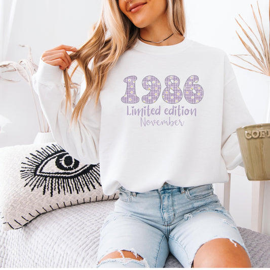White crewneck sweatshirt featuring floral patterned 1986 numbers with special edition June text, feminine retro birthday design for a 40th milestone celebration.