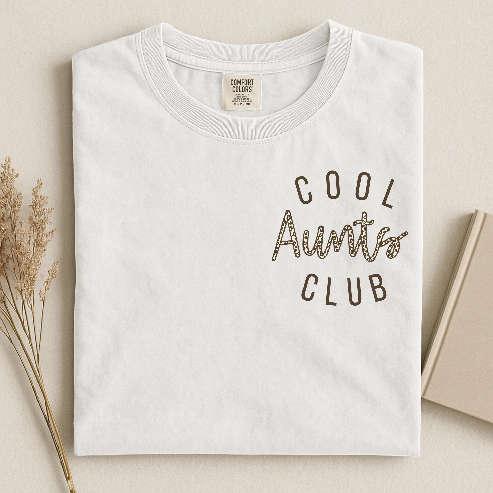folded white Comfort Colors® shirt with small blue "Cool Aunts Club" text on chest, perfect gift for trendy new auntie