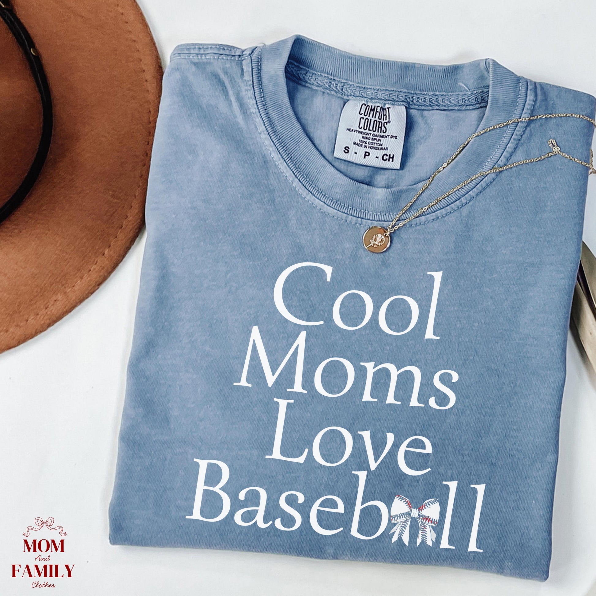 folded blue comfort colors® shirt with white text "Cool Moms Love Baseball", ideal for sporty moms or baseball game day outfits